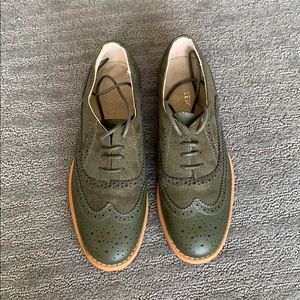 Green wingtip Oxford shoes